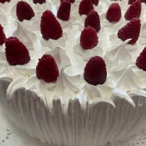 Torta de panqueques y frambuesas decorada con merengue